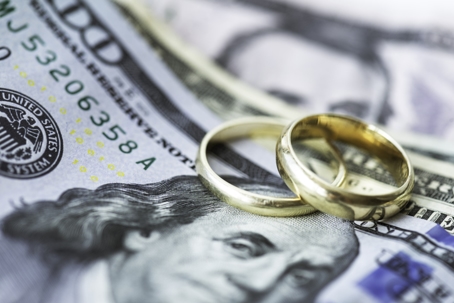 wedding rings on top of money