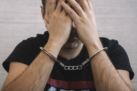 stressed man in handcuffs